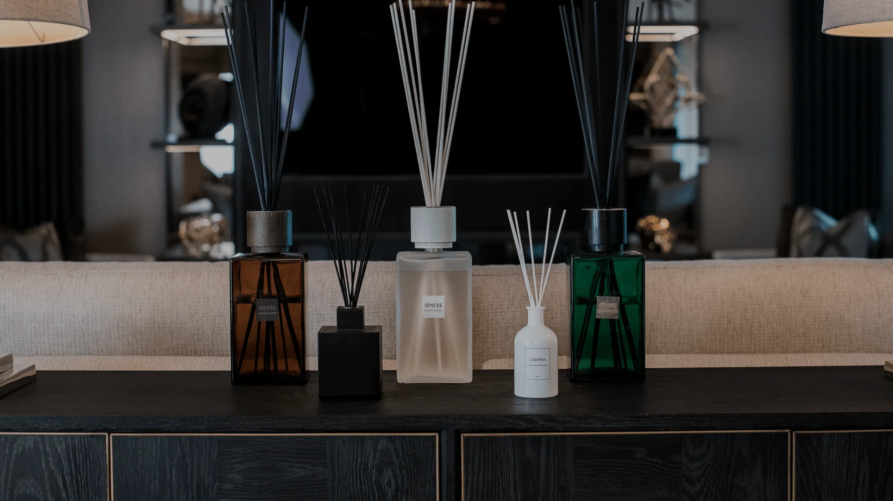 A curated lineup of luxury reed diffusers showcasing distinct glass vessel finishes, sizes, and reed styles.