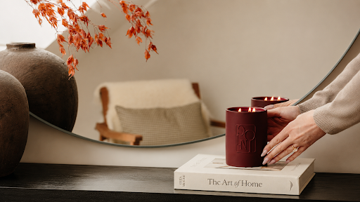 Woman lighting a candle while holding matches