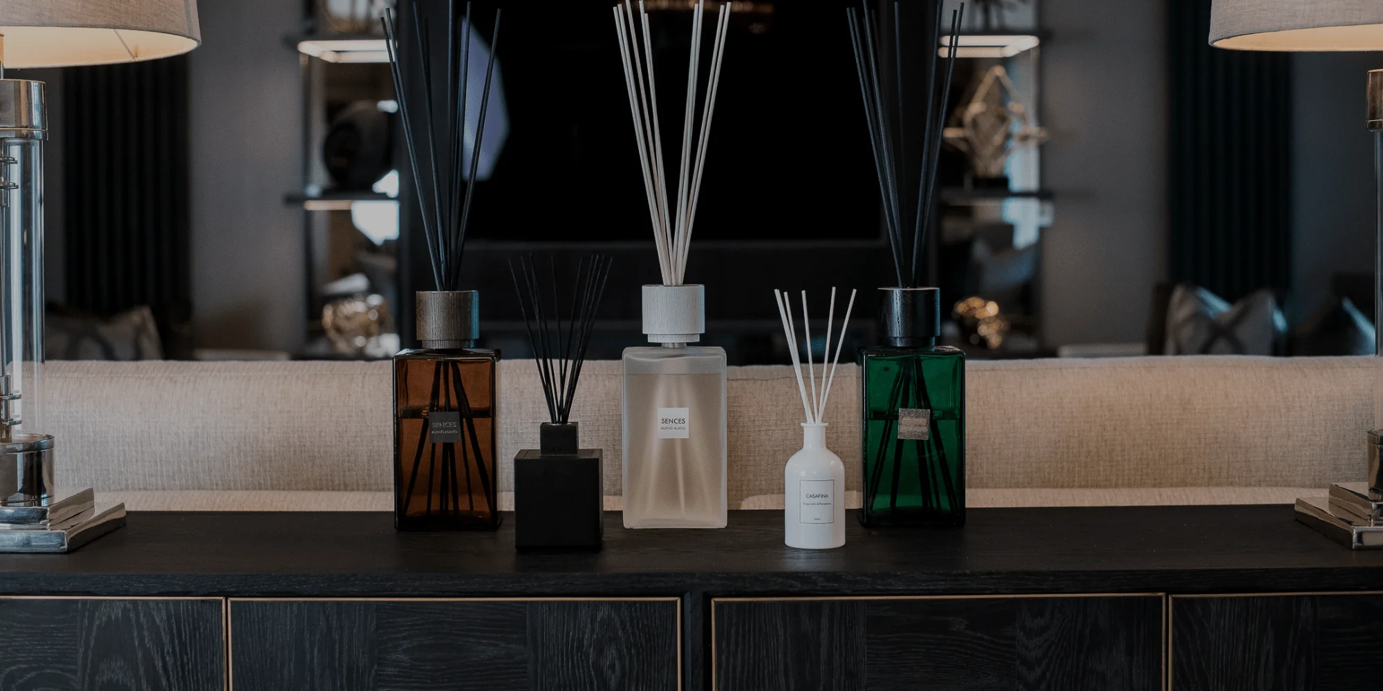 A curated lineup of luxury reed diffusers showcasing distinct glass vessel finishes, sizes, and reed styles.